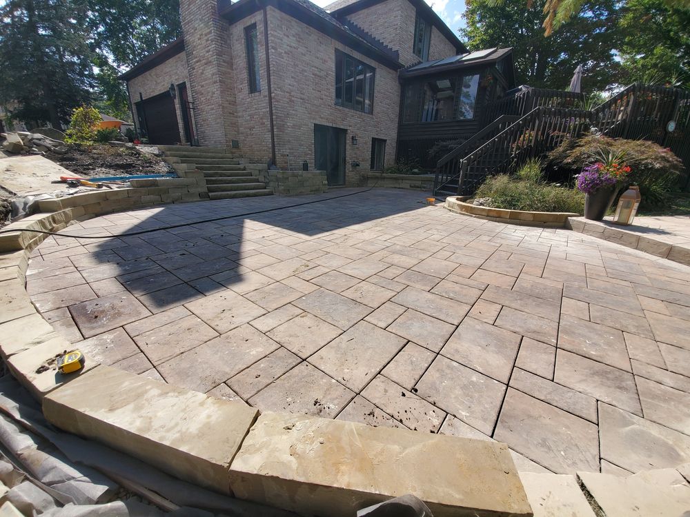 Multi-level paver terrace with sandstone block seat walls