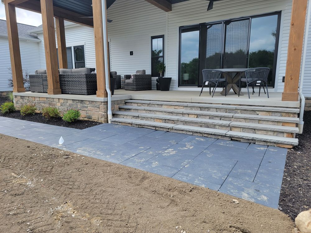Covered outdoor living room on timber posts with stone veneer base