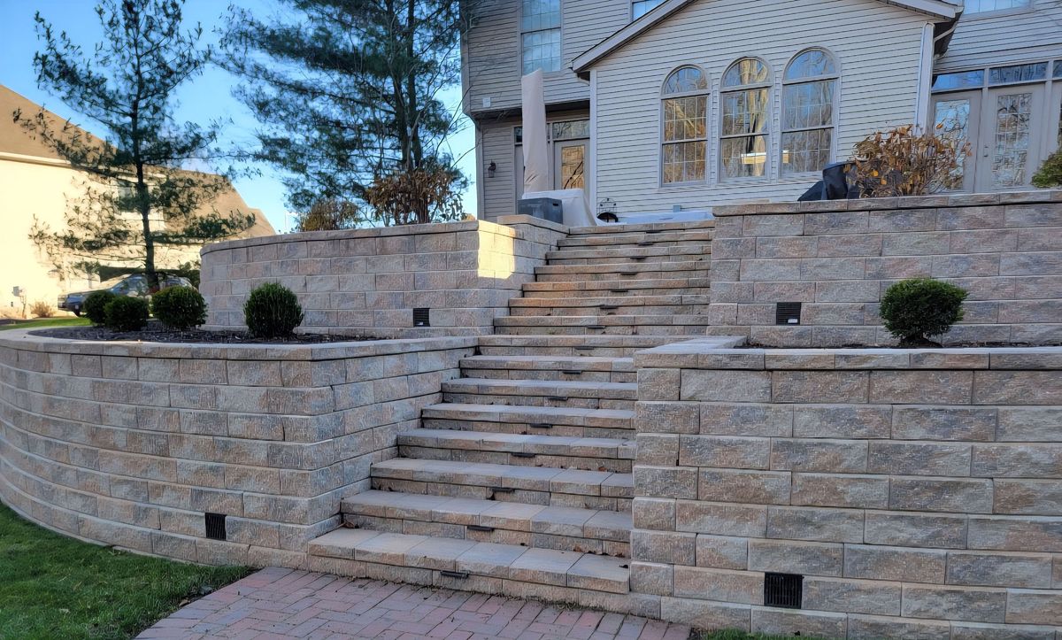 Tiered block retaining walls with a wide central stone staircase
