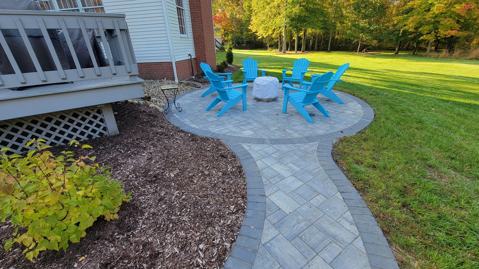 Circular paver patio with a fire pit and seating on a job in Summit County, Ohio