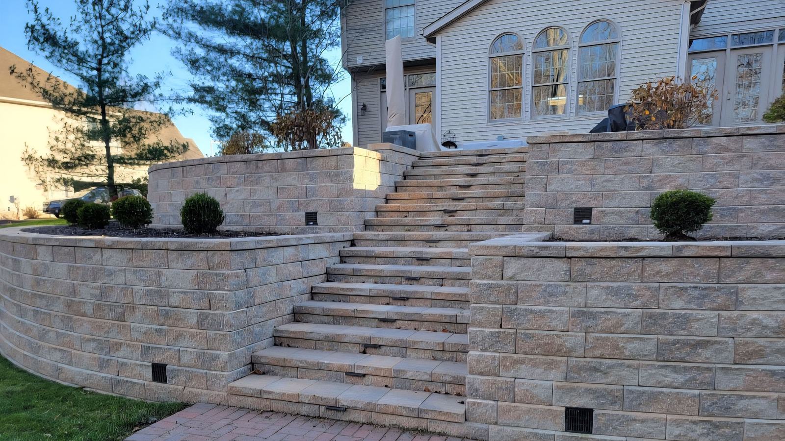 Tiered retaining wall and stone staircase built by Lasting Impressions in Portage County, Ohio