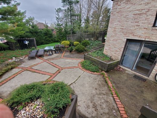 Before: cracked concrete patio with railroad-tie planters