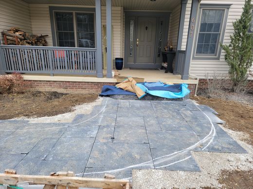 Border curves chalked onto laid pavers before cutting