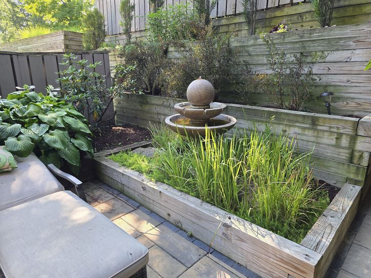 The same courtyard matured, with the ball fountain and ornamental grasses filled in